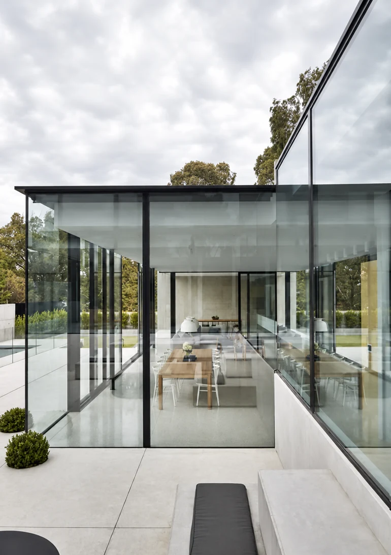 Glass pavilion with full-height glazing and views through to the dining space